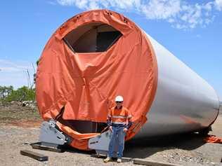 AGL's Michael Yeo next to one of the 30 metre tower sections of one of the wind turbines. Picture: Matt Collins