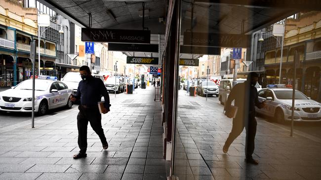 A man wears a face mask in Adelaide’s CBD last week. Picture: Tracey Nearmy/Getty Images)