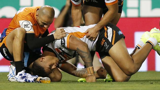 Michael Chee Kam of the Tigers receives attention after suffering a head knock during the Round 19 NRL match between the Newcastle Knights and the Wests Tigers at McDonald Jones Stadium in Newcastle, Friday, July 26, 2019. (AAP Image/Darren Pateman) NO ARCHIVING, EDITORIAL USE ONLY