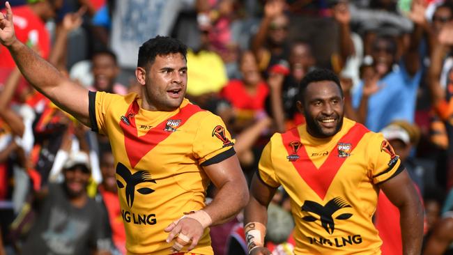 Papua New Guinea's Rhys Martin (left) celebrates after scoring a try during the Rugby League World Cup against Wales.