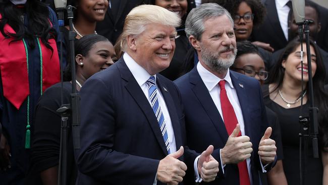 Donald Trump and Jerry Falwell, right, with members of gospel choir Lu Praise at Liberty University in Lynchburg, Virginia, in 2017. Picture: Getty Images