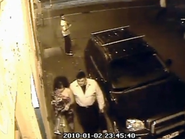 The couple pictured on CCTV walking back towards their car seconds before the attack.