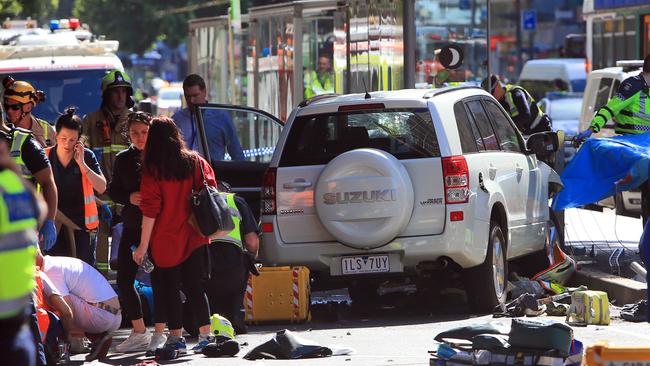 Emergency services workers treat the injured. Picture: Aaron Francis/The Australian