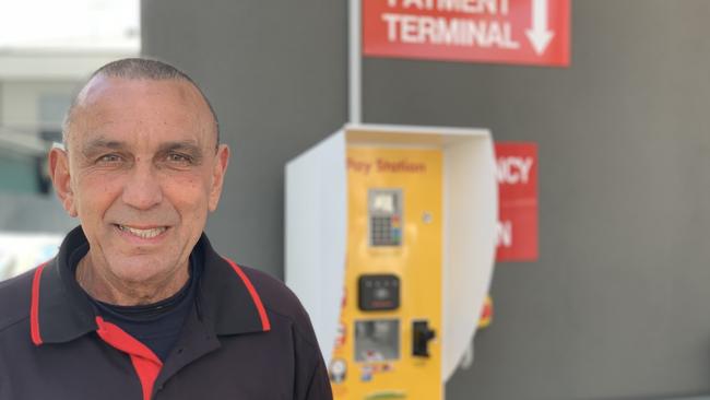 Silver’s Auto Centre owner Jimmy Rugari with the prepaid terminal on the wall of his Gilbert St service station that earns him money when he’s asleep. Picture: Tara Miko