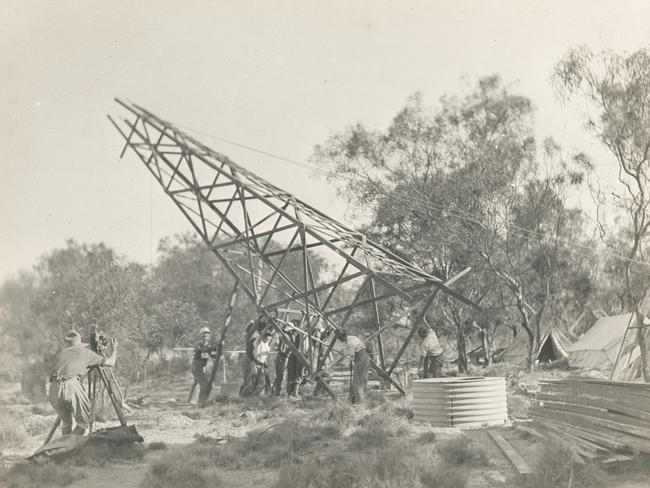 The scientists from the Wallal expedition erecting a wooden tower in scrubland.