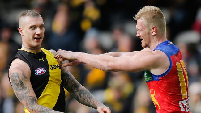 Dustin Martin of the Tigers (L) tussles with Nick Robertson of the Lions.