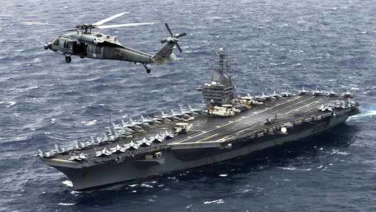 An MH-60S Sea Hawk Helicopter hovers above the aircraft carrier USS Nimitz in the Bay of Bengal in 2017. Picture: US Navy