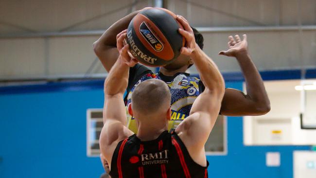 Coffey fights hard for every ball for RMIT. Photo: Basketball Victoria.