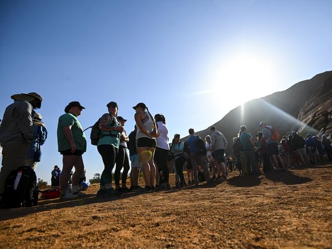 Tourists are seen lining up to climb Uluru, also known as Ayers Rock at Uluru-Kata Tjuta National Park in the Northern Territory, Friday. Picture: AAP