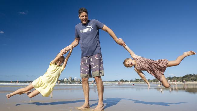 Richard Buckley playing on the beach with his daughters Emma 9, and Kate 6, while on holiday at Mooloolaba.