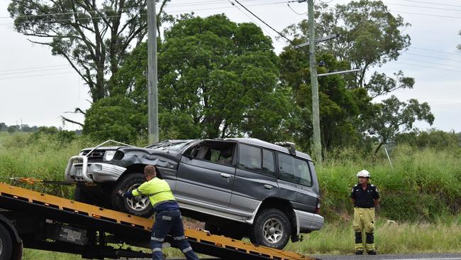 Two people were when a car rolled on the Bruce Highway near Bells Bridge on Friday morning, causing highway traffic delays.