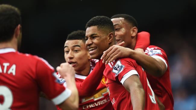 MANCHESTER, ENGLAND - MARCH 20: Marcus Rashford of Manchester United (2R) celebrates with team mates as he scores their first goal during the Barclays Premier League match between Manchester City and Manchester United at Etihad Stadium on March 20, 2016 in Manchester, United Kingdom. (Photo by Michael Regan/Getty Images)