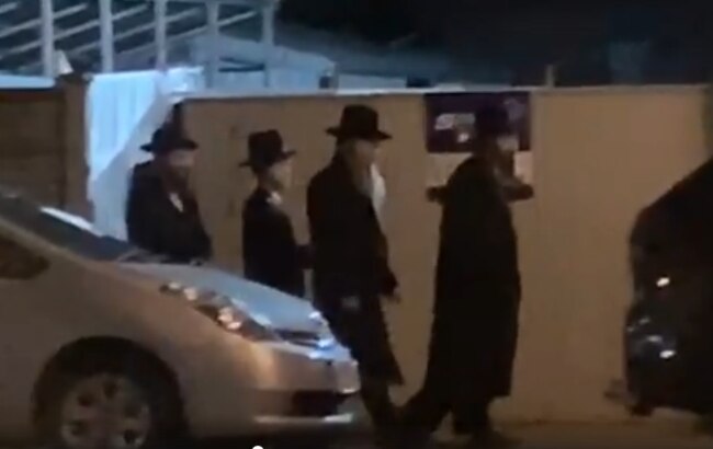 Still footage of a gathering of ultra-Orthodox Jews in Melbourne.