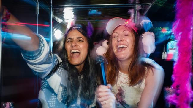Madeleine Sami and Celia Pacquola on a karaoke party bus in a scene from The Breaker Upperers.