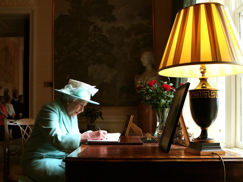 Queen Elizabeth II signs the visitor book prior to departing Hillsborough Castle in Belfast, Northern Ireland. (Photo by Brian Lawless – WPA Pool/Getty Images)