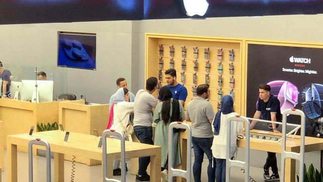 People shop at an Apple store in a shopping mall in Tehran in May. Picture: AFP