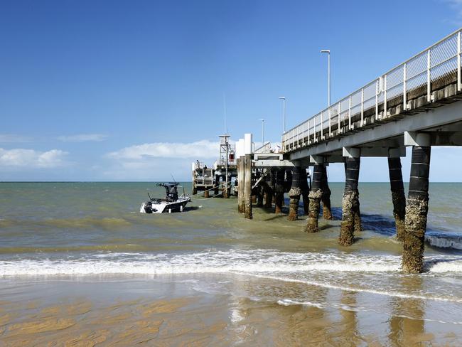 The lowest tide of the year has seen a lot of sand exposed on Palm Cove beach and left the jetty pylons high and dry. Picture: Brendan Radke