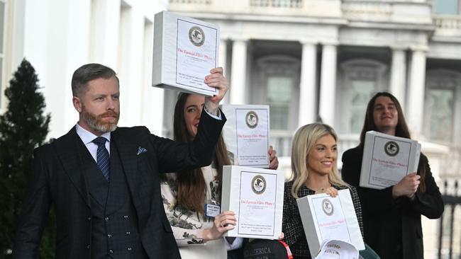 Senators carrying binders bearing the seal of the US Justice Department reading "The Epstein Files: Phase 1" walk out of the West Wing of the White House in Washington, DC. Picture: AFP