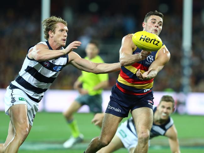 Crouch handballs in front of Josh Caddy. Picture: Sarah Reed