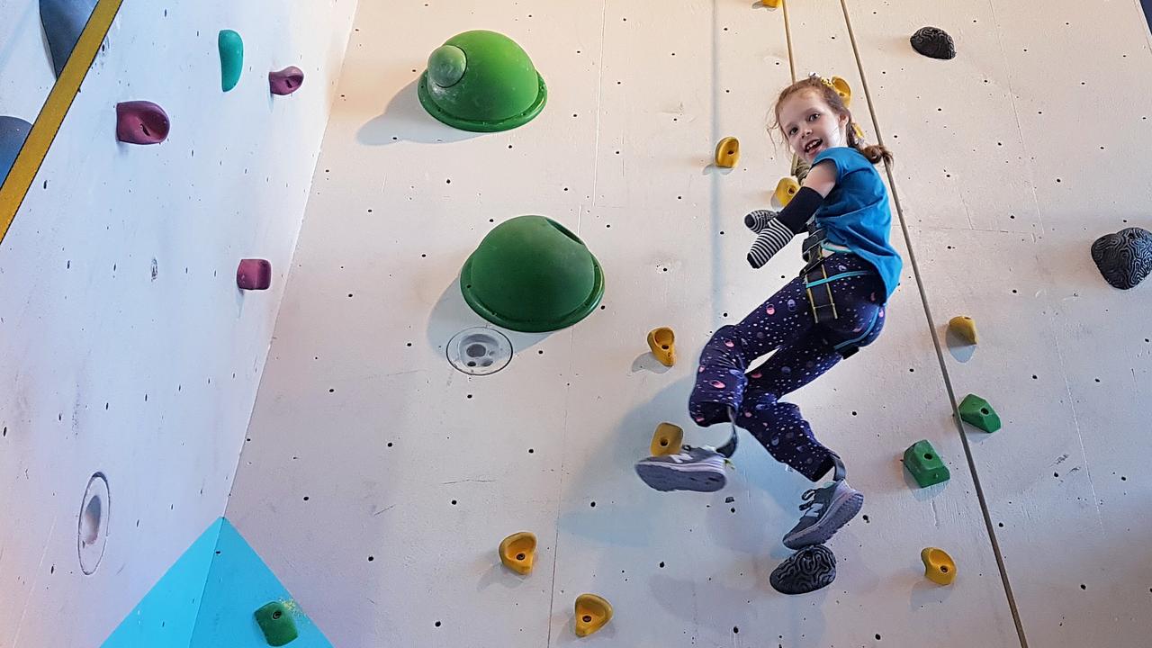 Mia Wilkinson rock climbing. She lost part of all four limbs to sepsis more than three years ago.