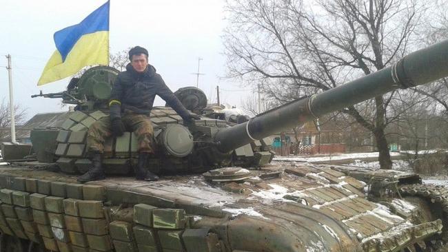 Supplied  A Ukrainian soldier on top of a Russian tank. Picture: Twitter.