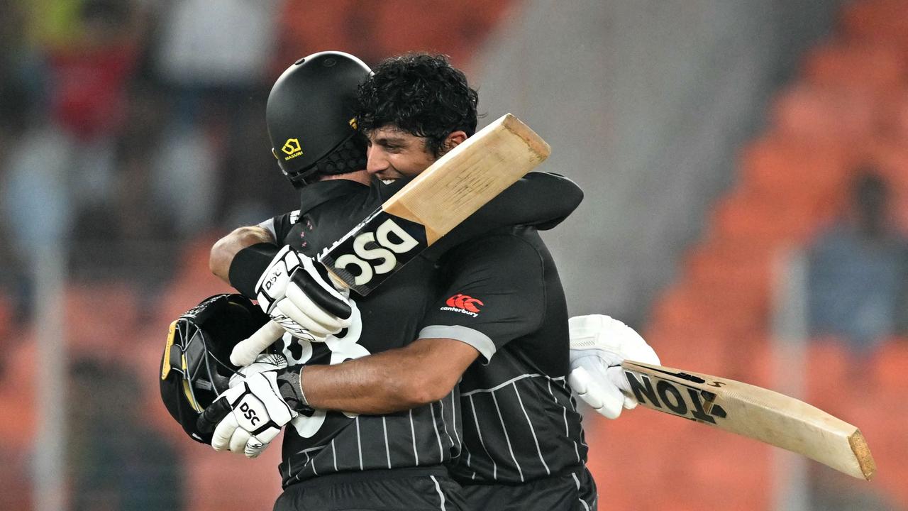 Rachin Ravindra celebrates with Devon Conway after scoring a century. (Photo by Sajjad HUSSAIN / AFP)