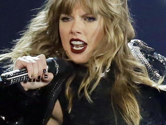 FILE - This May 8, 2018 file photo shows Taylor Swift performing during her "Reputation Stadium Tour" opener in Glendale, Ariz. Swift says she may not be performing at the American Music Awards because the men who own her old recordings wonâ€™t allow her to play her songs.  Swift said on Instagram Thursday that she planned to play a medley of her hits when sheâ€™s named Artist of the Decade at the American Music Awards on Nov. 24. But Swift says the men who own the music, Scooter Braun and Scott Borchetta, are calling the performance an illegal re-recording.  (Photo by Rick Scuteri/Invision/AP, File)