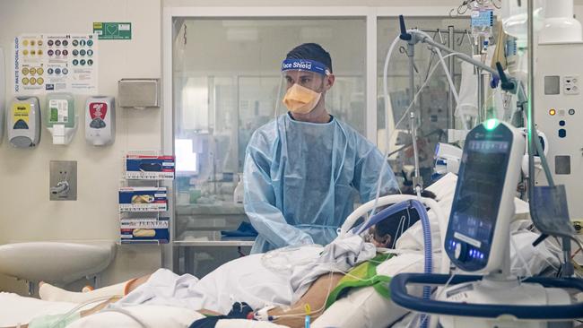 A nurse works with a COVID patient in the ICU at the Royal Melbourne Hospital. Picture: Aaron Francis