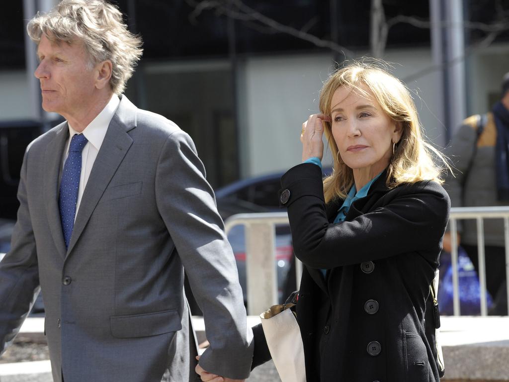 Actress Felicity Huffman enters court in Boston with her brother.  Picture:  AFP