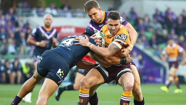 Broncos fullback Darius Boyd is wrapped up by the Storm defence. Picture: Getty Images