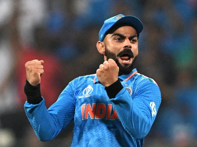 India's Virat Kohli celebrates after the dismissal of New Zealand's Daryl Mitchell during the 2023 ICC Men's Cricket World Cup one-day international (ODI) first semi-final match between India and New Zealand at the Wankhede Stadium in Mumbai on November 15, 2023. (Photo by Punit PARANJPE / AFP) / -- IMAGE RESTRICTED TO EDITORIAL USE - STRICTLY NO COMMERCIAL USE --