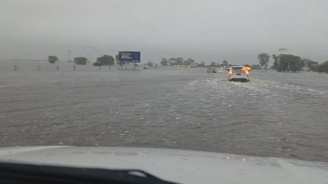 The Bruce Highway has flooded in the Whitsundays, with cars stopped in floodwaters near Goorganga. Photo: CJ Magee