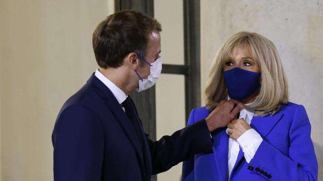 Macron and his wife share a moment. Picture: AFP