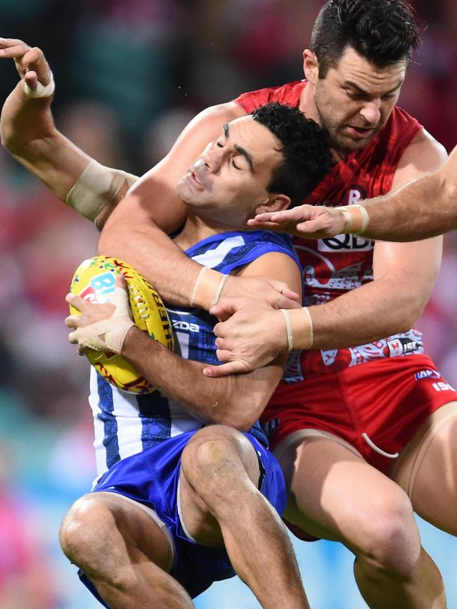 Lindsay Thomas is collared by Sydney’s Heath Grundy.