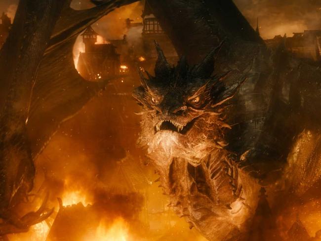 Smaug the dragon destroys a town in a scene from the film adaptation of <i>The Hobbit</i>. Riddles and hoarding have long been dragon traits. Picture: Metro-Goldwyn-Mayer / The Hobbit