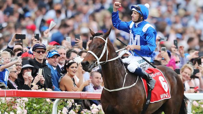 Hugh Bowman celebrates riding Winx to a fourth straight Cox Plate.