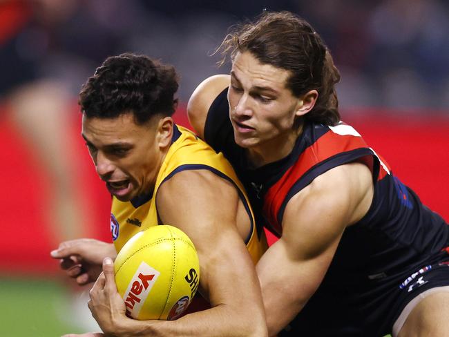 AFL Round 17. Essendon vs Adelaide at Marvel Stadium, Melbourne. 09/07/2021.  Archie Perkins of the Bombers tackled Ben Davis of the Crows during the 2nd qtr.     .  Pic: Michael Klein