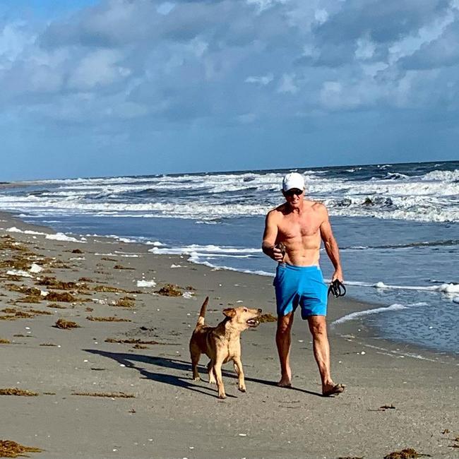 Greg Norman walks his dog in Florida.