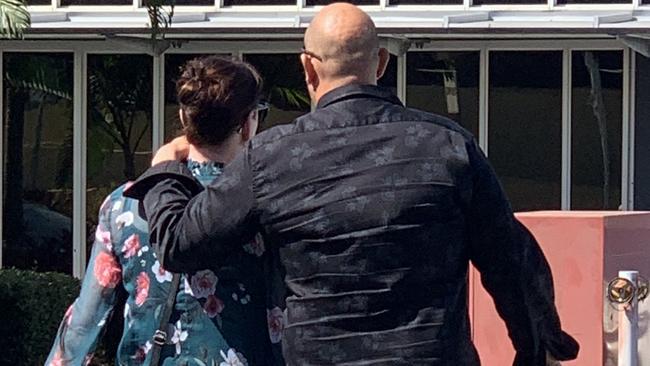 Hospital social worker Sarah Maree Simpson (left) and a man rush from Mackay courthouse after she was fined $2000 and a conviction was recorded for unlawfully accessing a restricted computer.