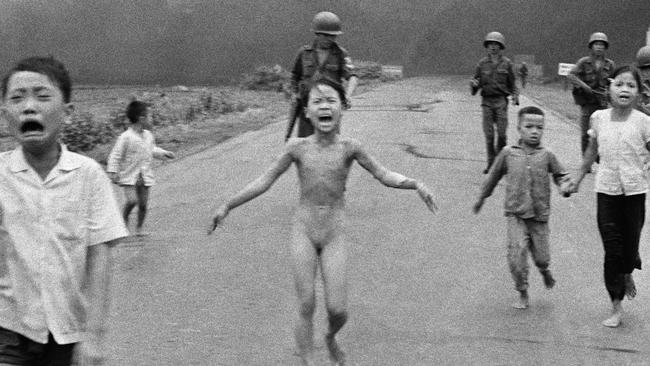 In this 08 Jun 1972 file photo, crying children, including 9-year-old Kim Phuc, centre, run down Route 1 near Trang Bang, Vietnam after an aerial napalm attack on suspected Viet Cong hiding places as South Vietnamese forces from the 25th Division walk behind them. A South Vietnamese plane accidentally dropped its flaming napalm on South Vietnamese troops and civilians. From left, the children are Phan Thanh Tam, younger brother of Kim Phuc, who lost an eye, Phan Thanh Phouc, youngest brother of Kim Phuc, Kim Phuc, and Kim's cousins Ho Van Bon, and Ho Thi Ting. (AP Photo/Nick Ut)