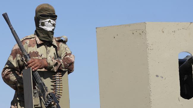 A member of the armed forces wearing a “death mask”. Picture: AFP.