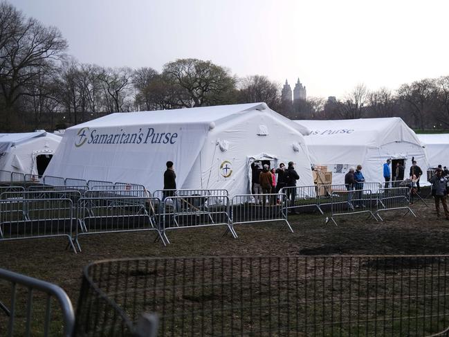 Members of the international Christian humanitarian organisation Samaritans's Purse, put the finishing touches on a field hospital in New York's Central Park during the height of New York’s COVID-19 outbreak in March. Picture: Spencer Platt/Getty Images/AFP