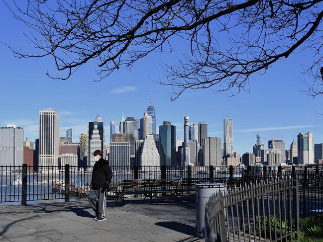 A man wearing a face mask takes a walk on the usually busy Brooklyn Heights Promenade in Brooklyn. Picture: AFP