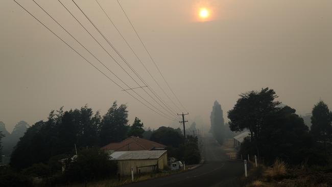 Smoke cloaks the Tasmanian town of Geeveston. Picture: Chris Kidd