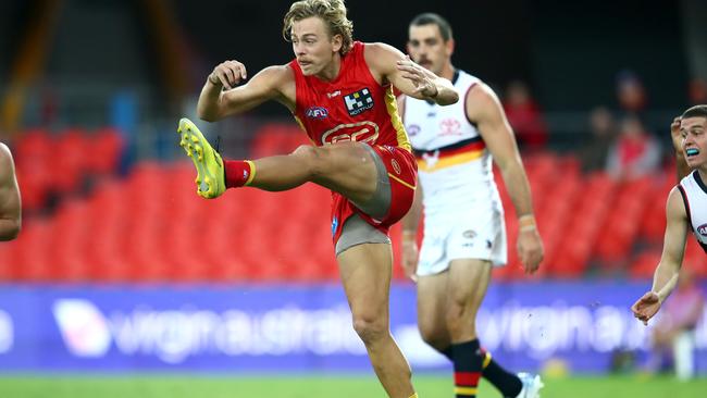 GOLD COAST, AUSTRALIA - JUNE 21: Hugh Greenwood of the Suns kicks the ball during the round 3 AFL match between the Gold Coast Suns and the Adelaide Crows at Metricon Stadium on June 21, 2020 in Gold Coast, Australia. (Photo by Jono Searle/AFL Photos/via Getty Images )