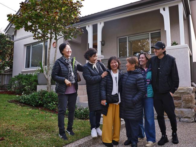 WEEKEND TELEGRAPH - 25.5.24MUST CHECK WITH PIC EDITOR BEOFRE USE - Auction at 9 Penkivil St, Willoughby NSW. Sold for $3.65M. Happy vendor Pam Joh (middle in yellow pants) pictured with family and friends. Picture: Sam Ruttyn