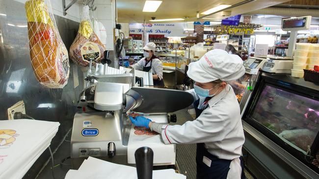 Emi Habgood works in the deli at Piedmonte's Supermarket in Fitzroy North. Picture: Paul Jeffers