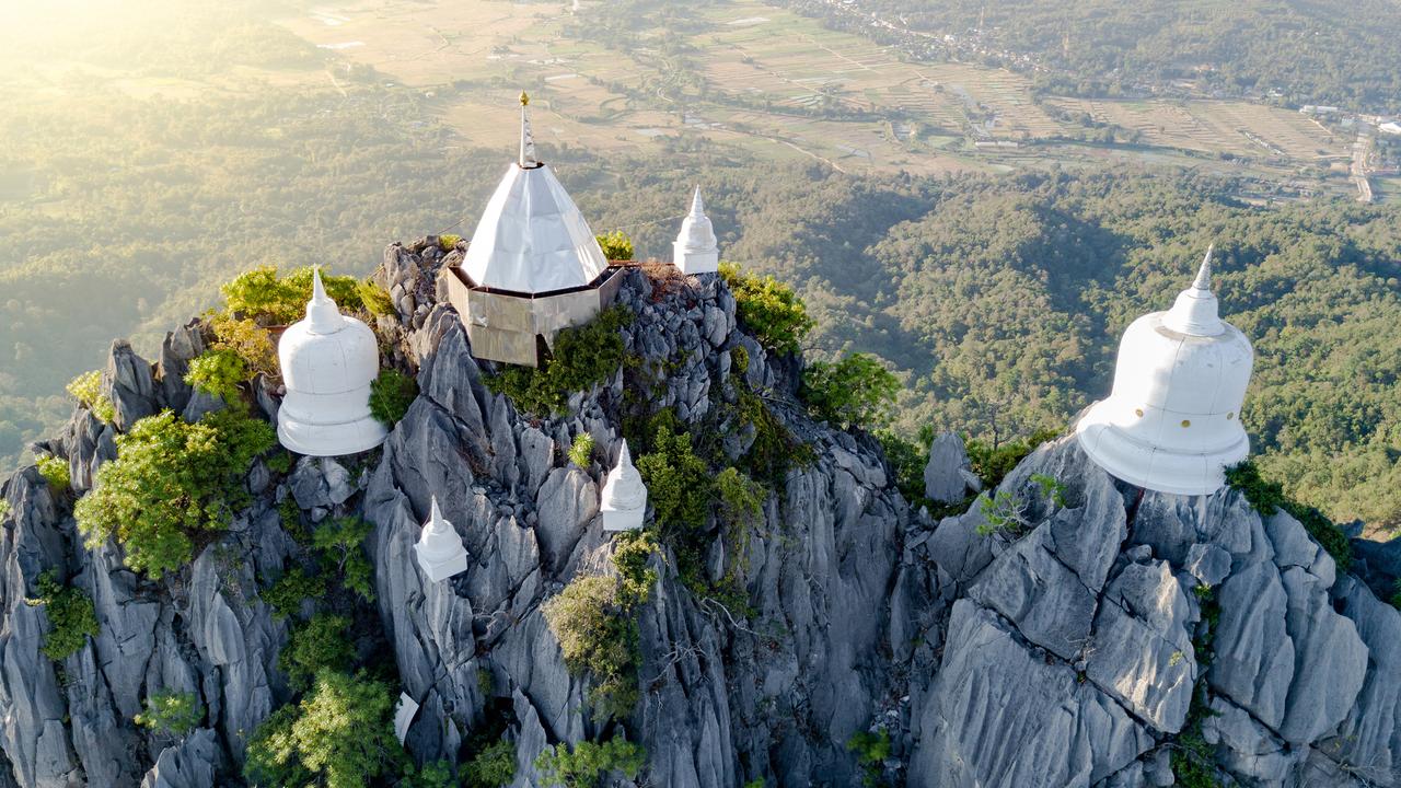 See Thailand's floating Pagodas hovering mystically from their perch high on the mist-shrouded peaks.