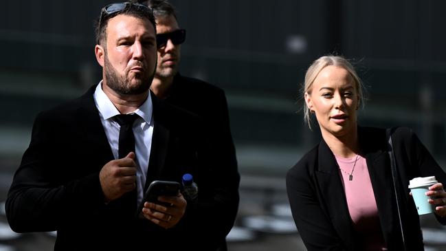 Gold Coast builder Dustin Rodway with his wife (in pink) arrives at the Supreme Court in Brisbane Picture: NCA NewsWire