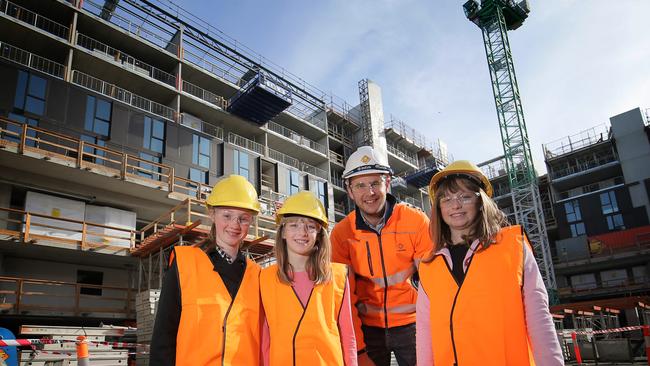 From left, Scarlett Neil, 11, Jasmine Neil, 11, and Hayley Rice, 11, are shown around the university’s accommodation site by Adrian DeJong from Fairbrother. Picture: RICHARD JUPE